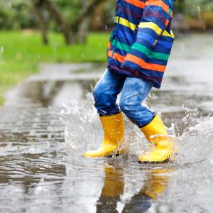 Child splashing in a puddle