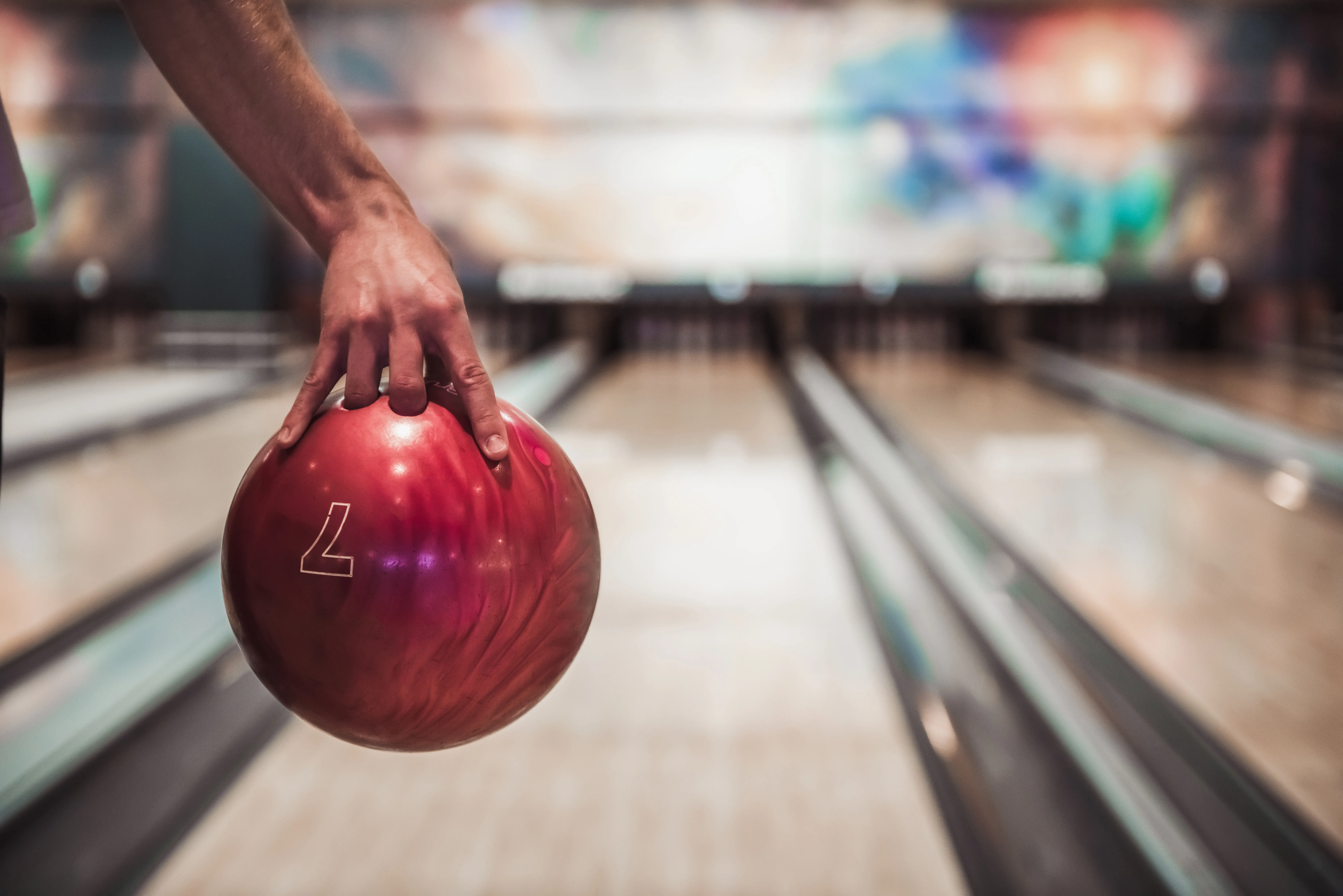 CLose up for a bowling ball, with the lane and pins in the background