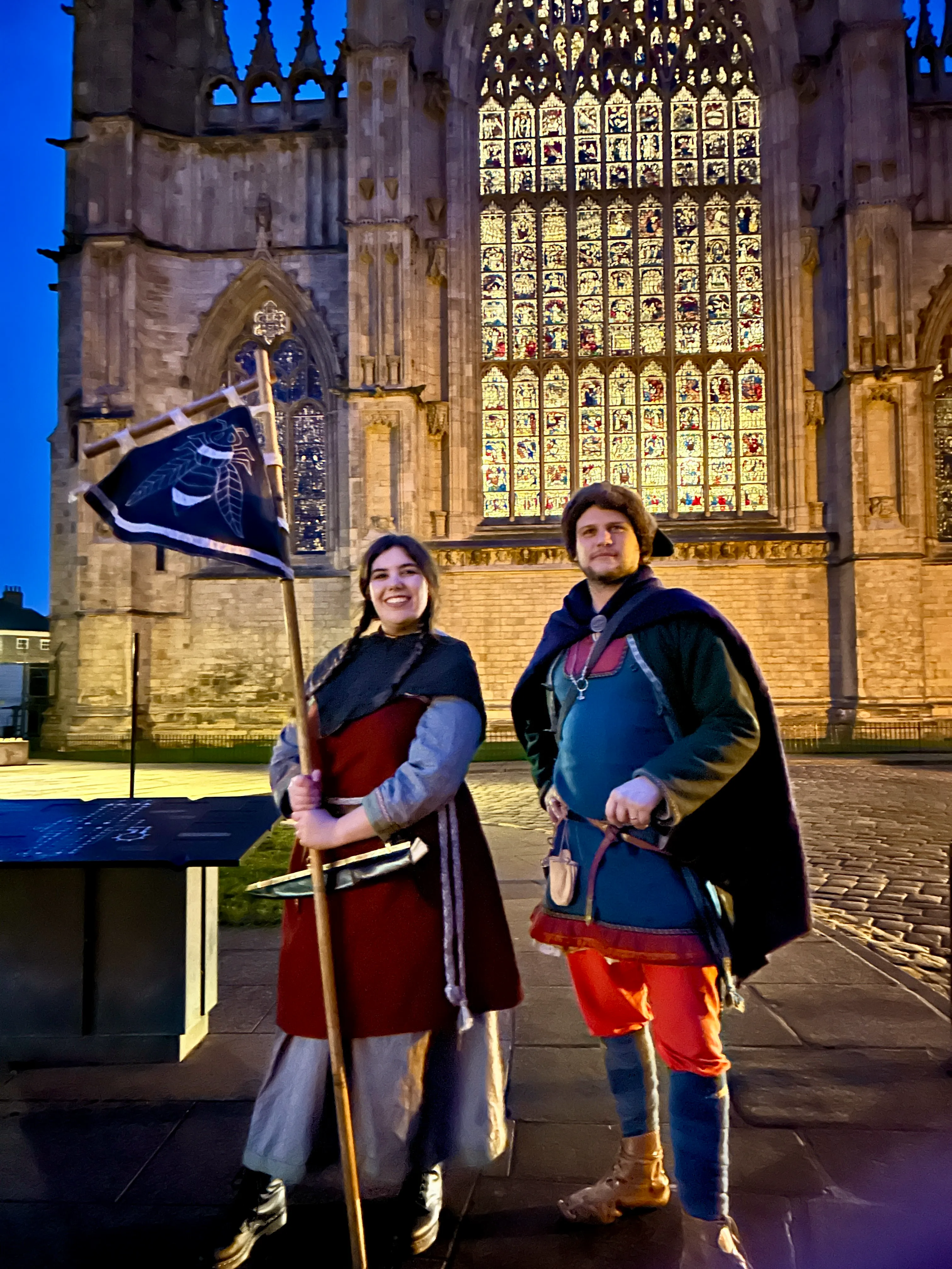Viking tour guides in full authentic Norse garb leading visitors through medieval York streets.
