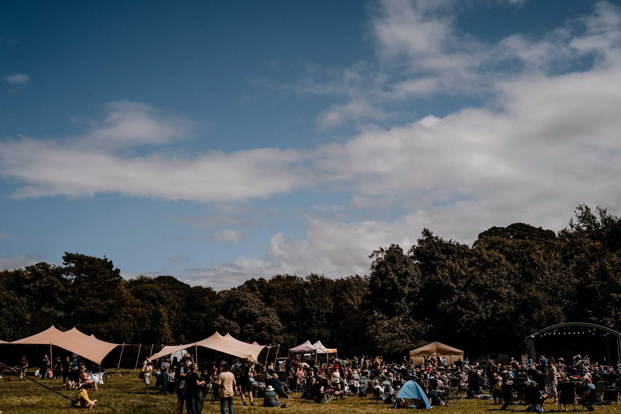 View across the Magpies Music Festival with marquees and people, event in August in North Yorkshire
