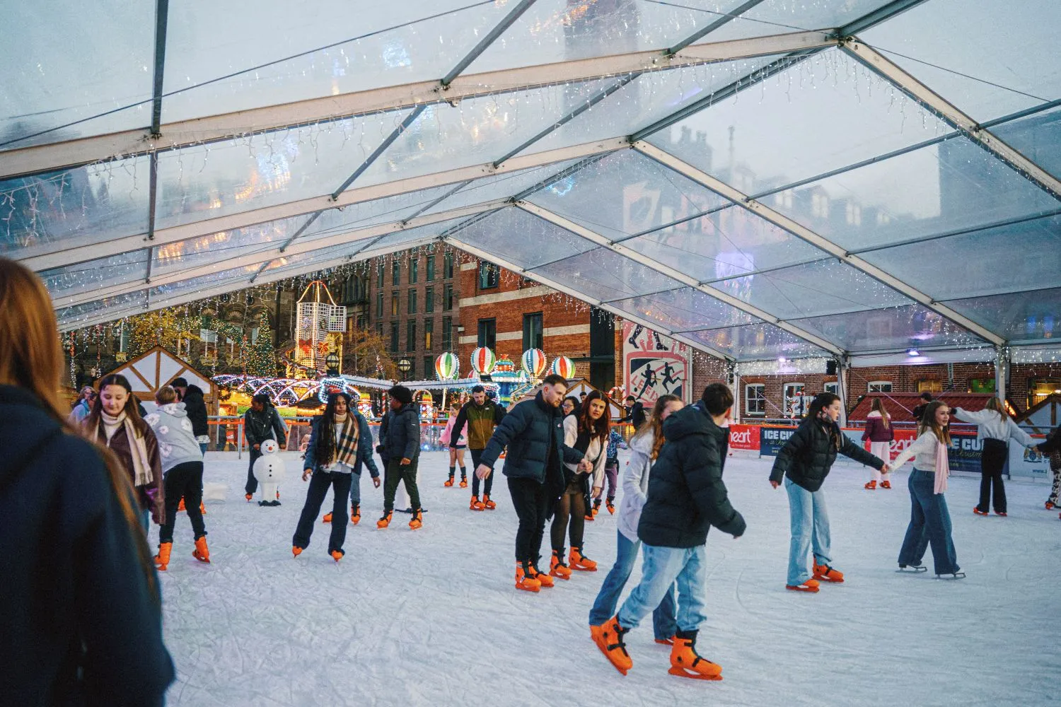 Skaters enjoying the covered real ice rink on Millennium Square during Ice Cube at Christmas in Leeds