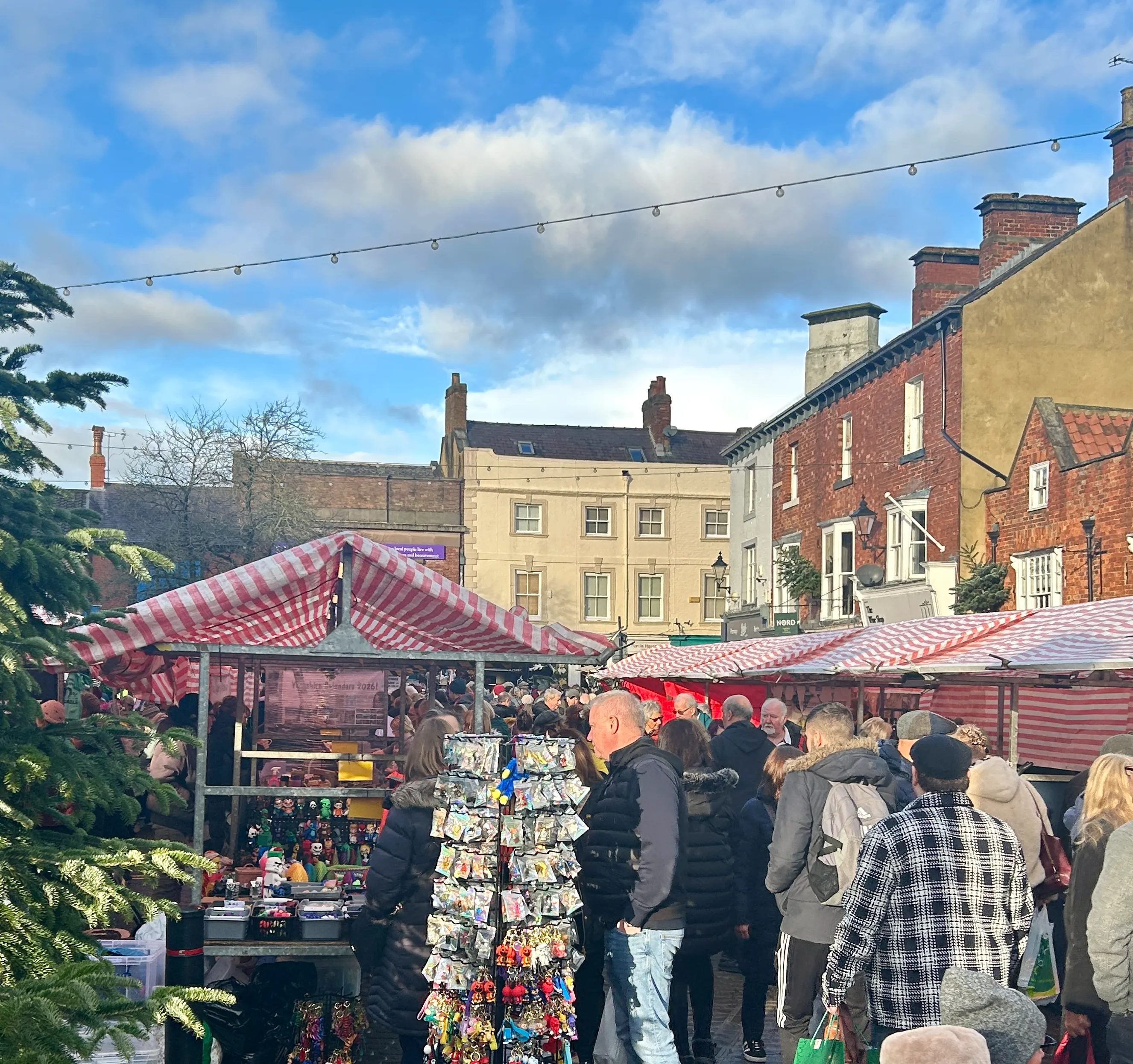 Festive wooden stalls and twinkling lights in historic Knaresborough Market Place during the Christmas Market