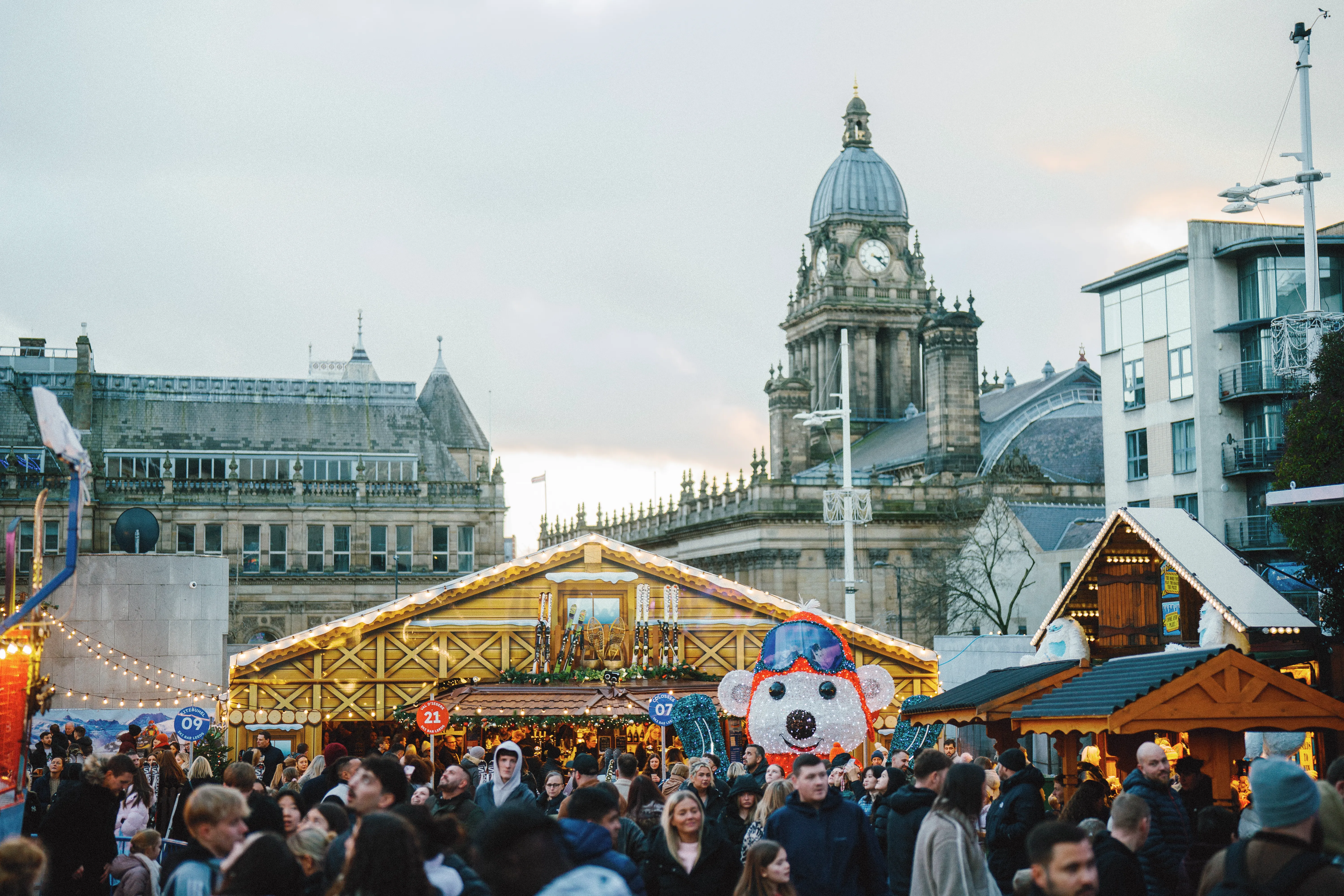 Festive market stalls and decorated Christmas trees in City Square Leeds