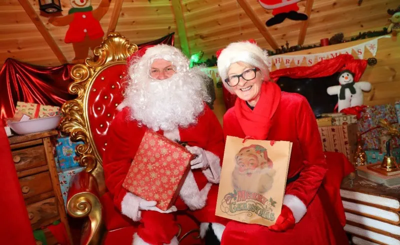 Santa Claus and festive characters outside Santa's Grotto at the Tropical Butterfly House
