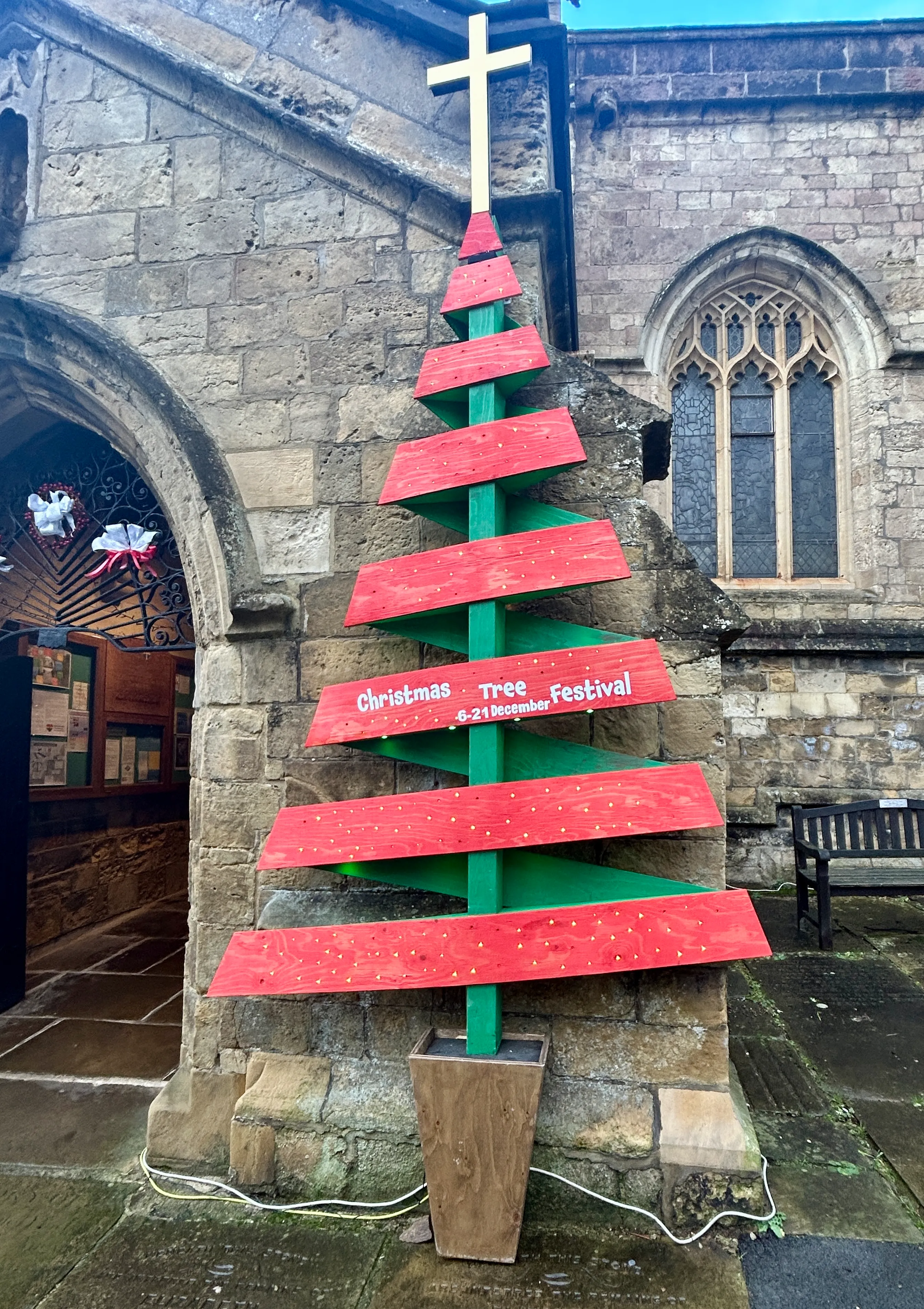 A stunning row of brightly lit decorated Christmas trees inside historic St John's Parish Church Knaresborough