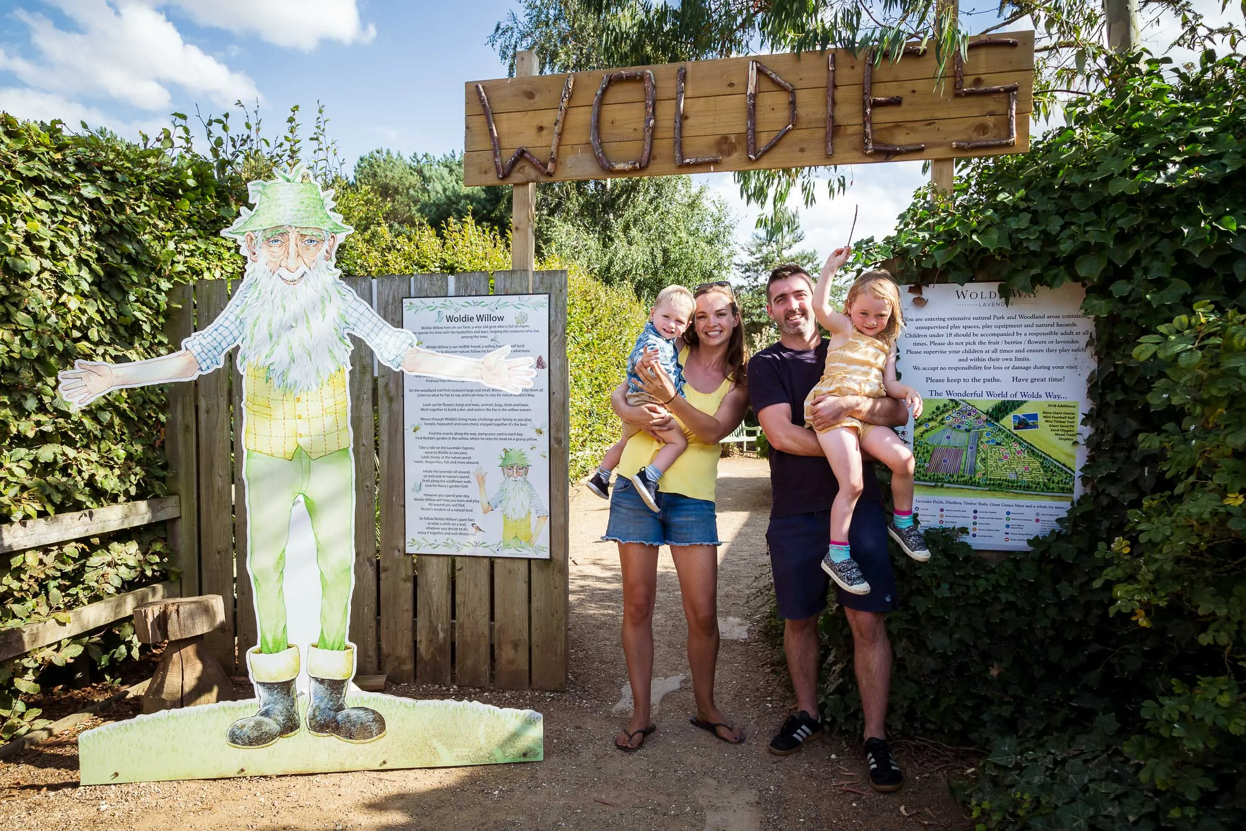 Family at the entrance to Woldies Nature Play, Trails and Gardens.