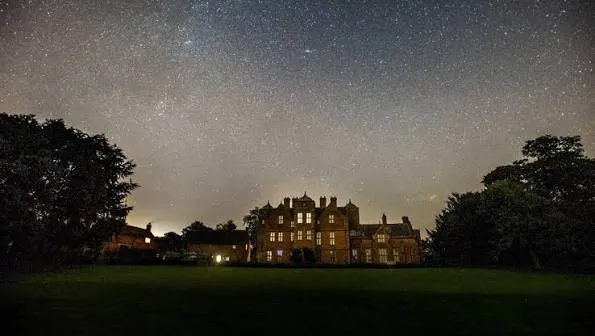 Atmospheric historic hall illuminated at night for the After Hours Ghost Tours at Kiplin Hall