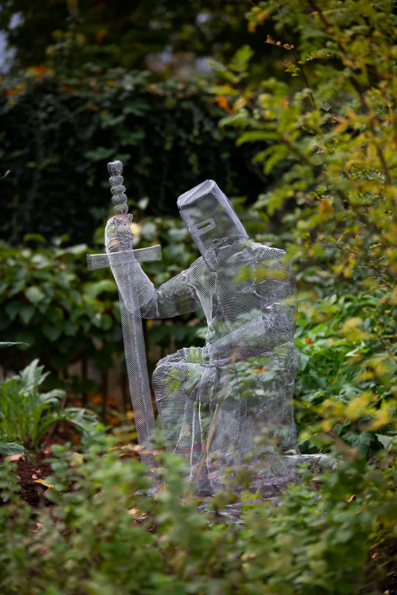 Knight ghost sculpture kneeling in the edible gardens in York