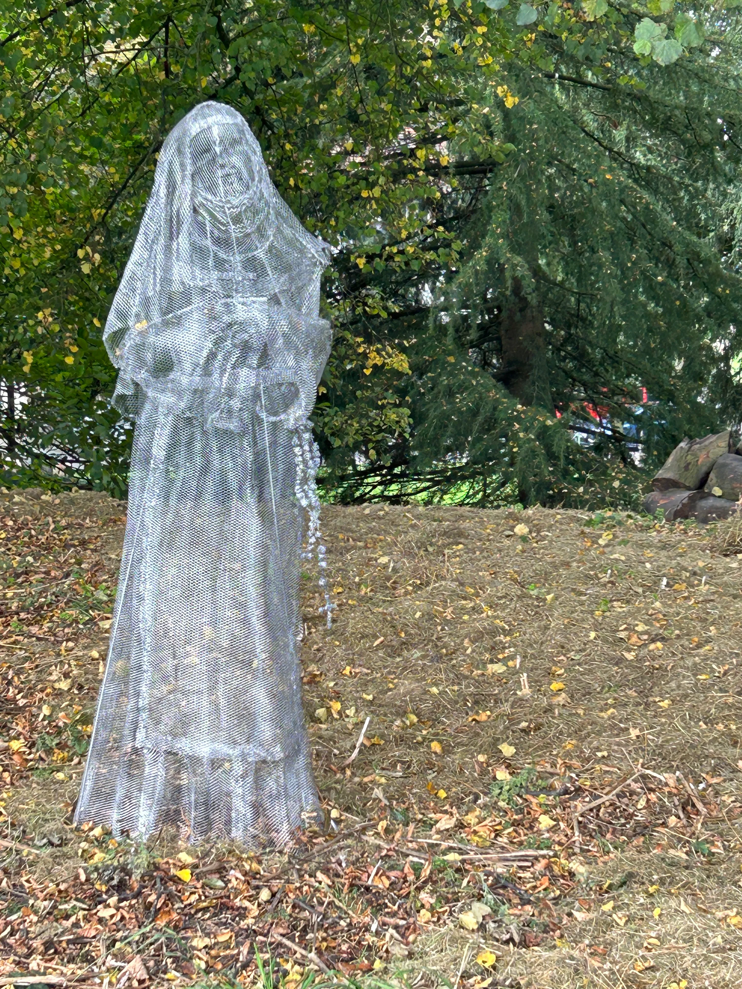 Wire mesh ghost sculpture of a lady