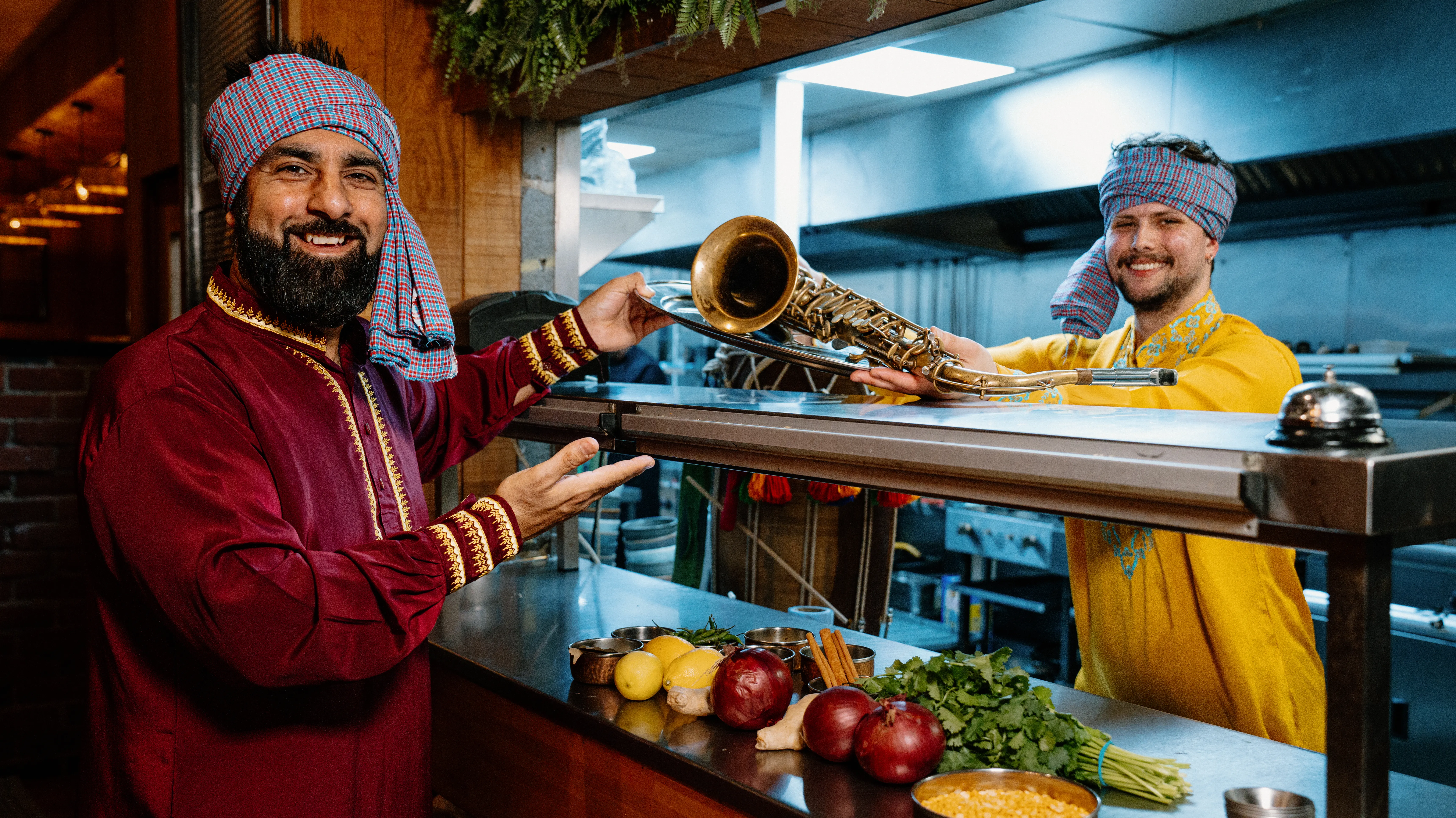 musicians in brightly coloured punjab tradional clothes part of bradford festival in July