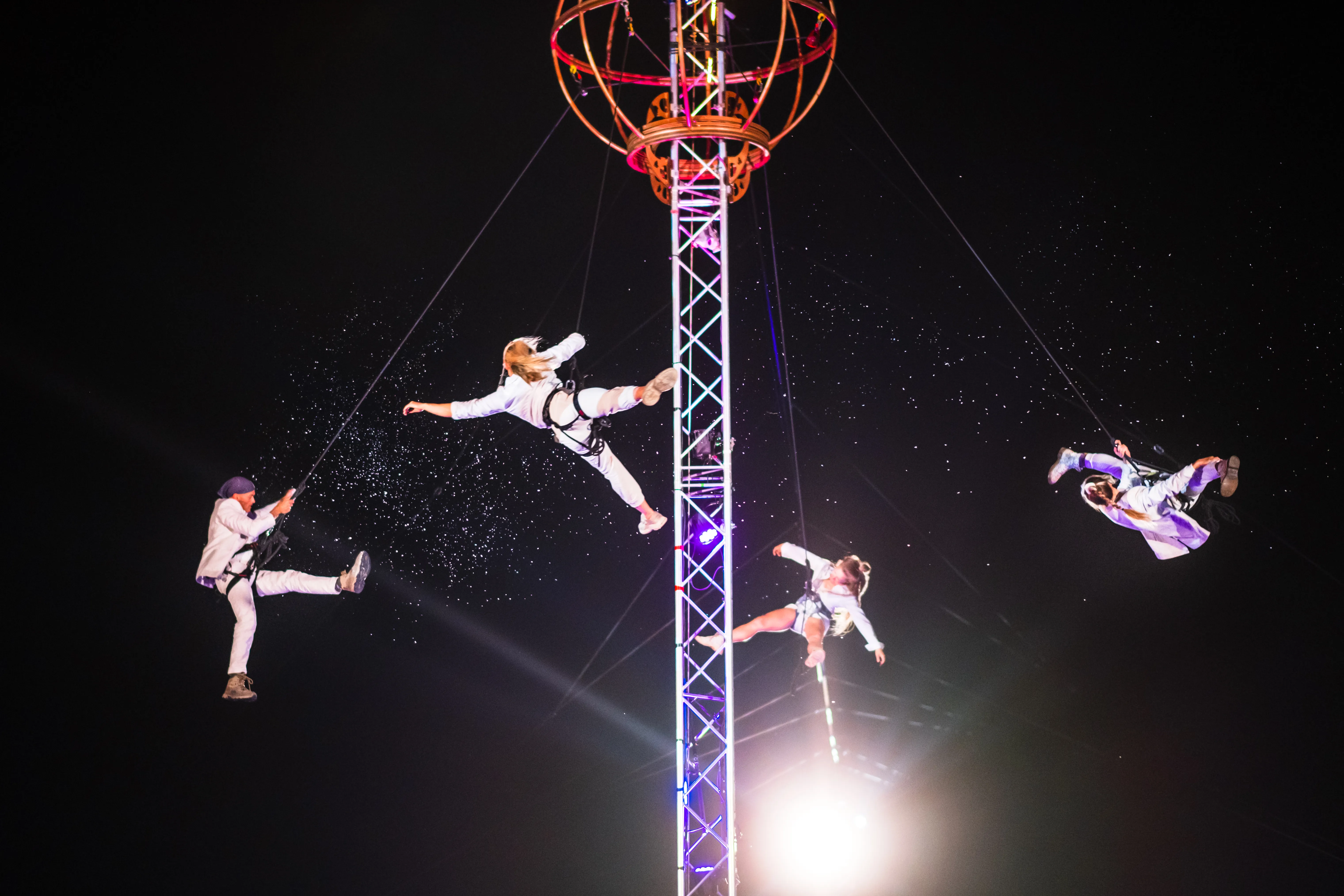 artistes on a high wire act, spinning above the crowd at the July 2026 Bradford festival