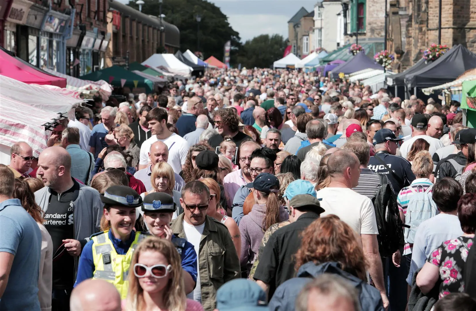 people browing at stalls in the artisan market at the Saltburn Food Festival