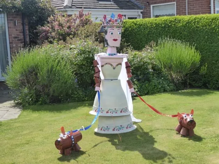 FLowerpot queen with two flowerpot corgis at the Flamborough Flowerpot Festival in June 2026