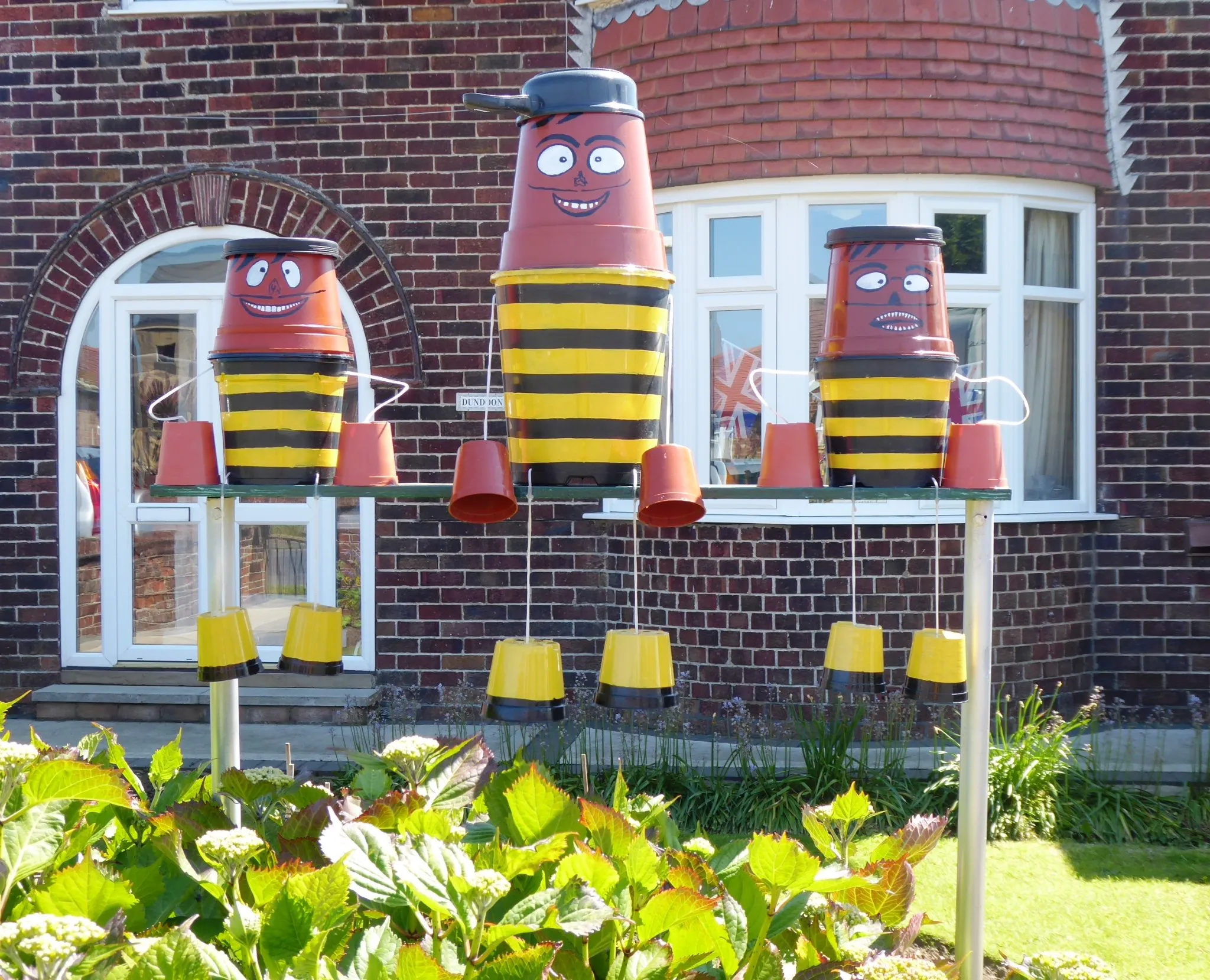 three flowerpot characters at the Flamborough Flowerpot Festival in June 2026