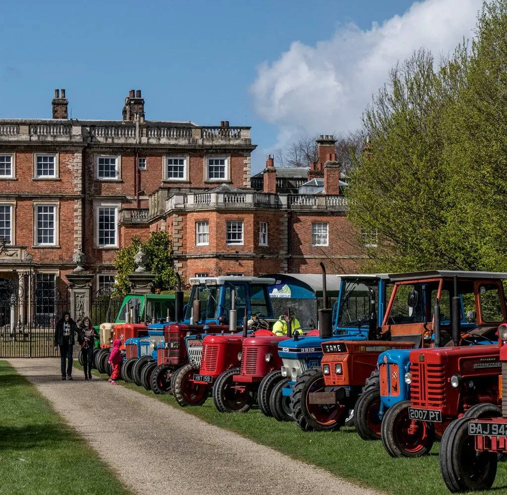 ROw of tractors in front of NEwby Hall in North Yorkshire, at the Tractor Festival in June