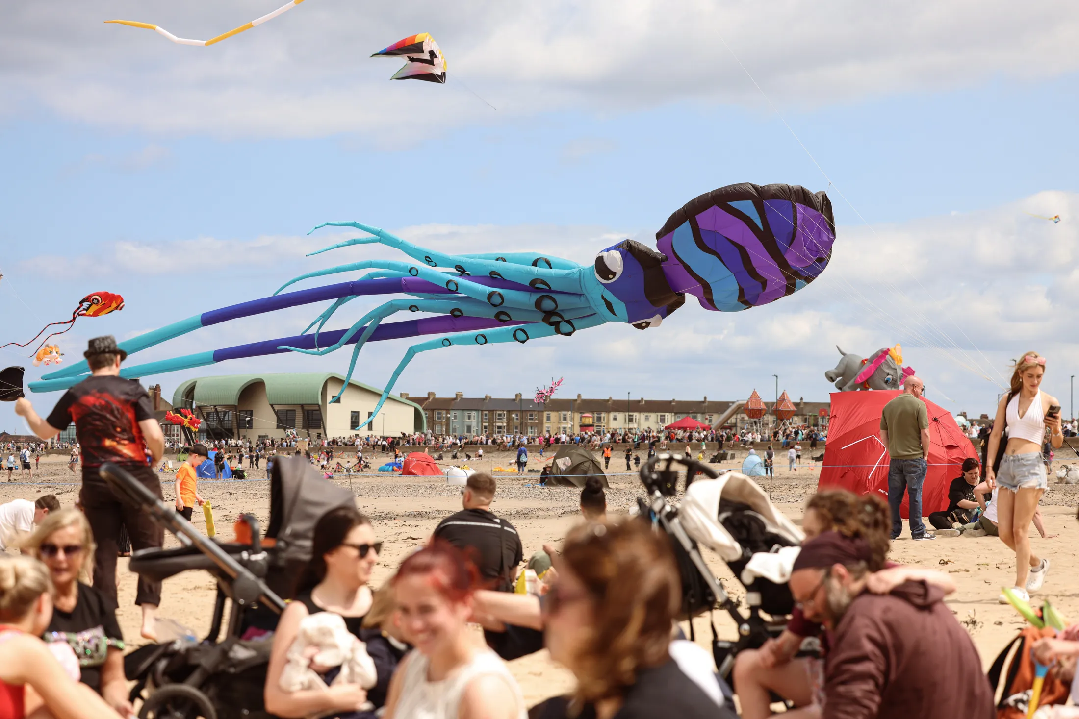 Giant octopus kite flying above people's heads at Redcar Kite Festival held annually in June