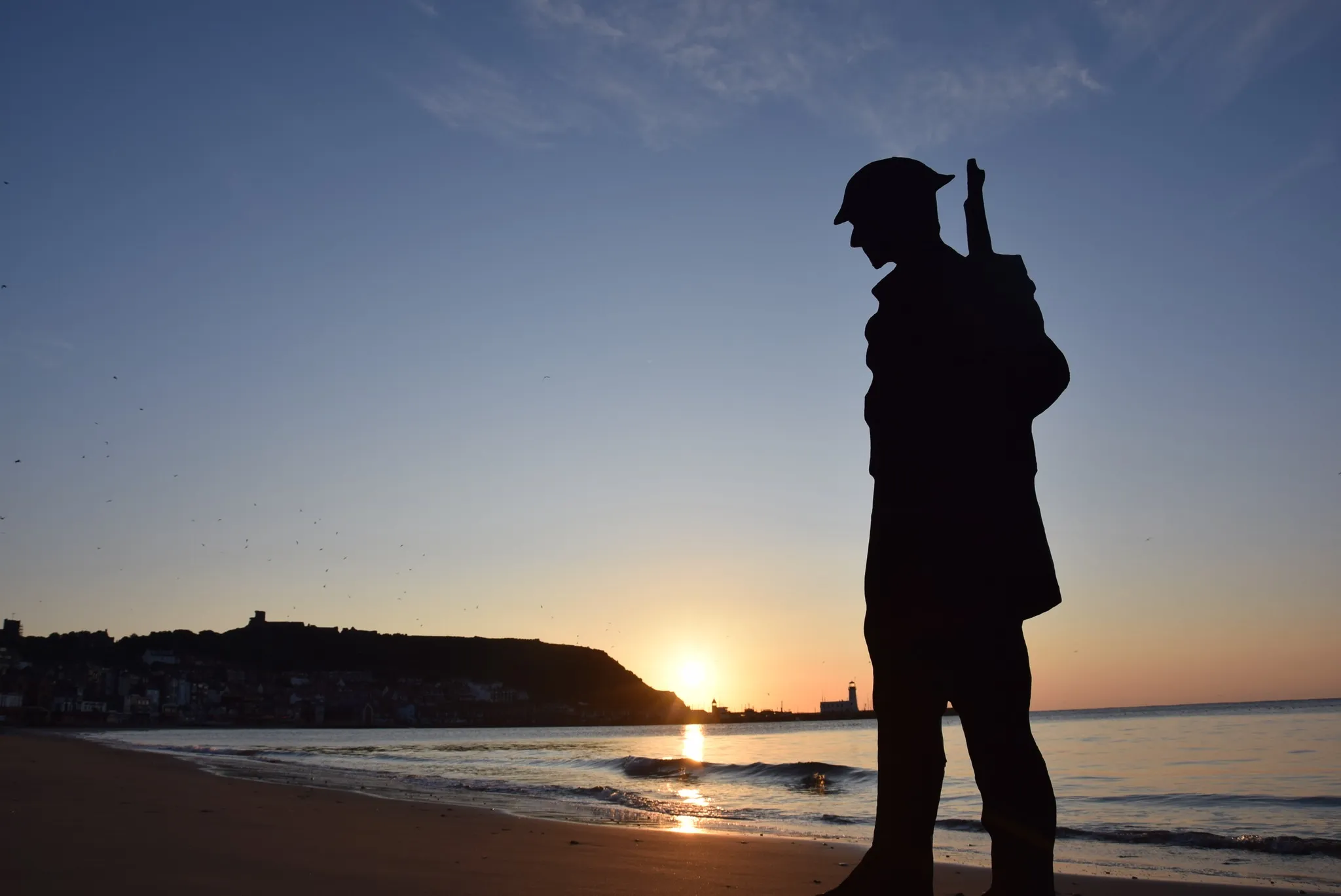 silhouette of a tommy soldier against sunset on scarborough beach