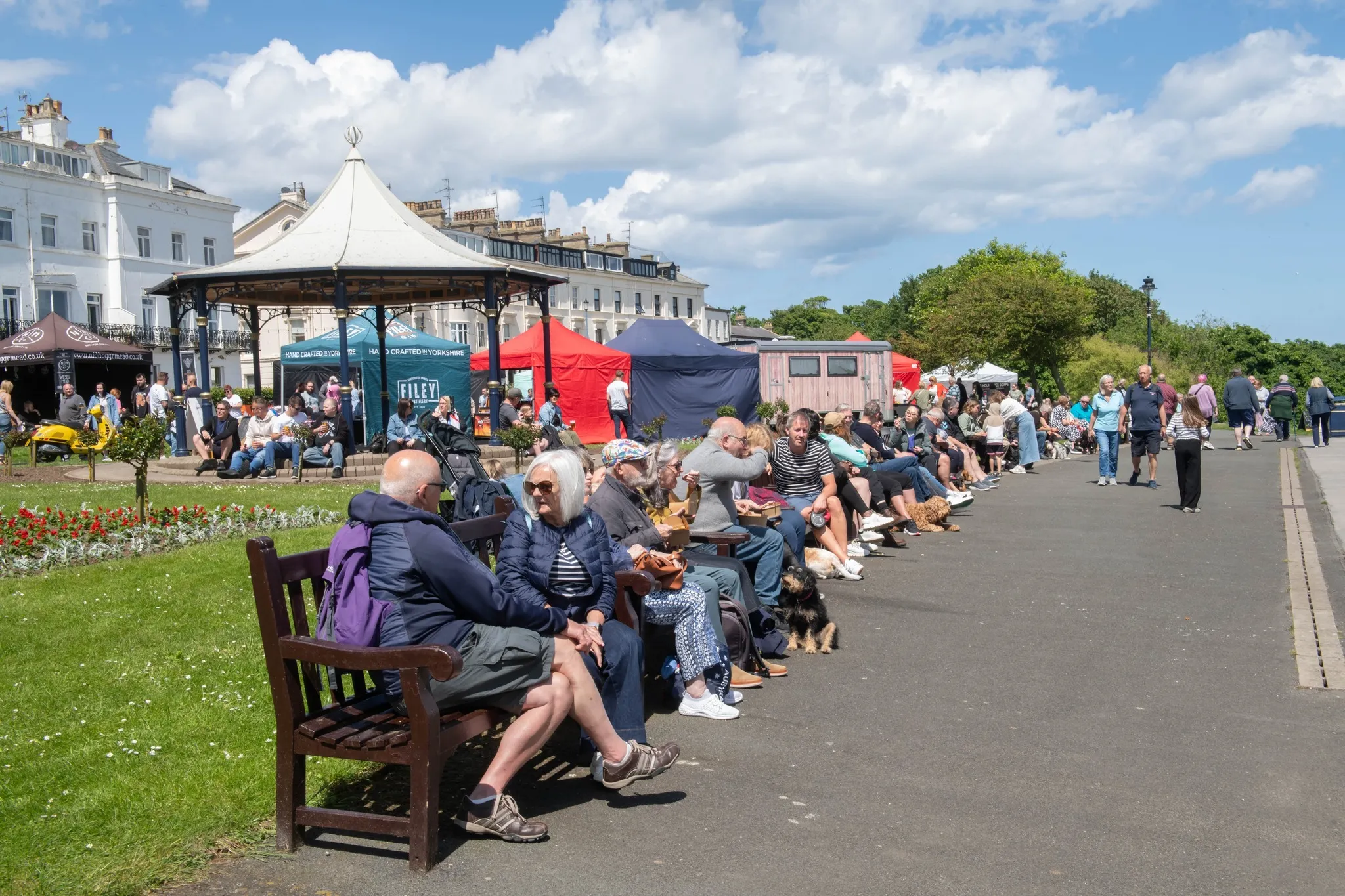 benches, people and stalls along the promenade in Filey during the food festival
