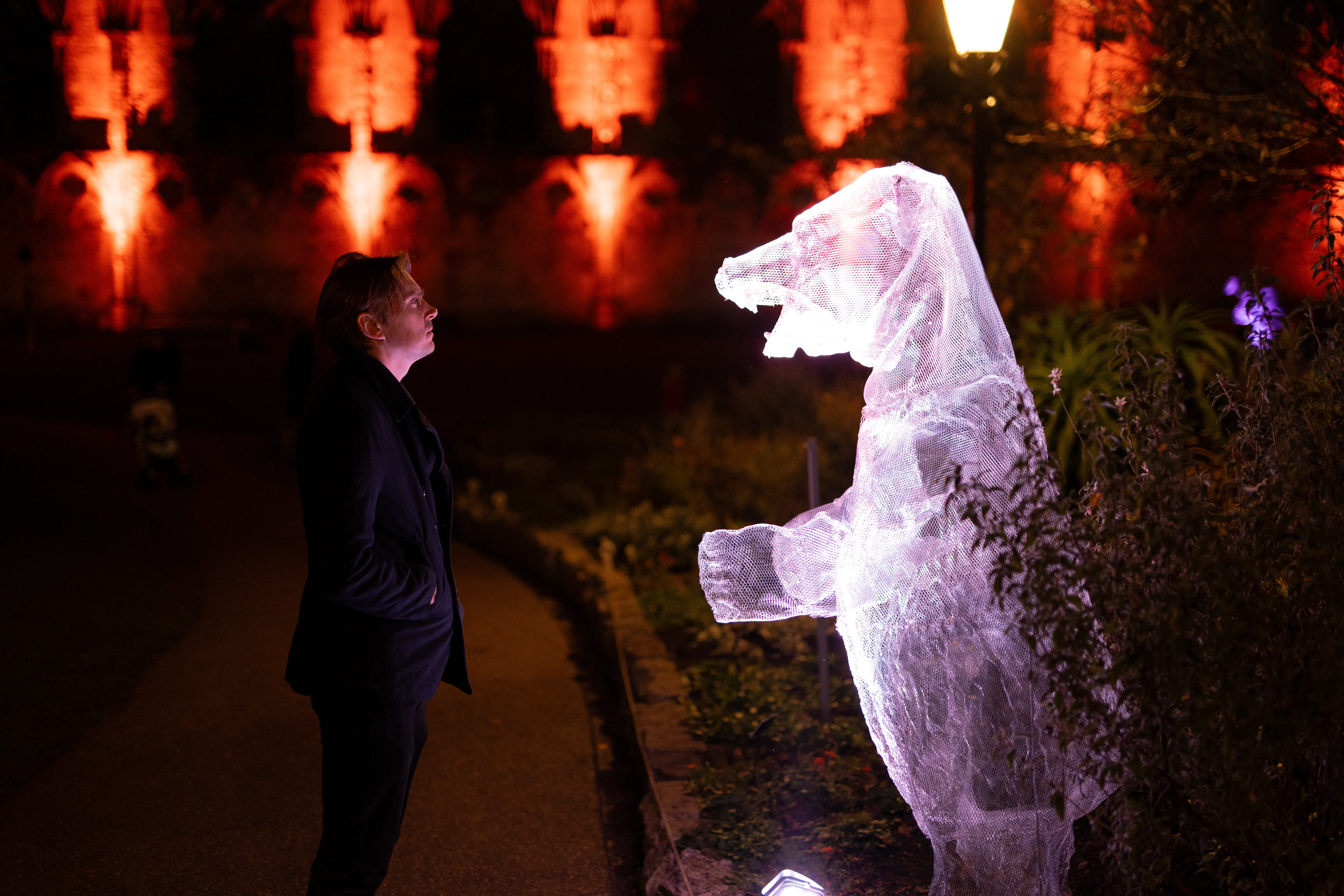 Visitor poised in front of the York Bear Ghost.