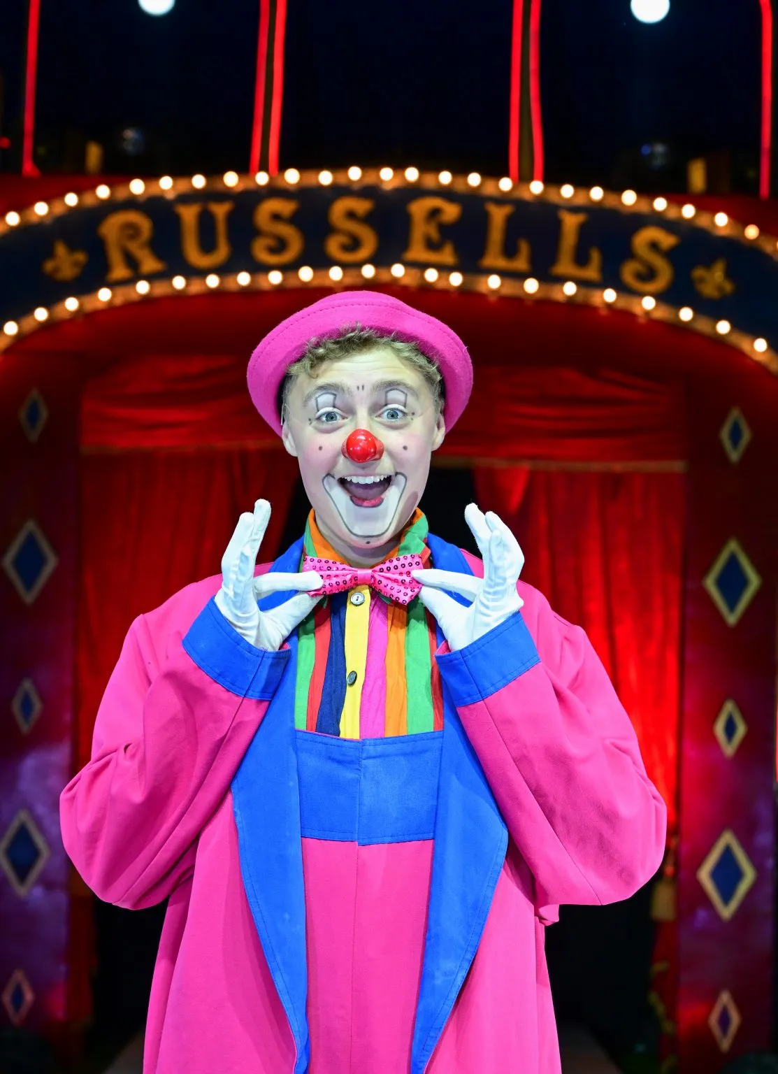 Circus clown performing comedic acts for families in the ring