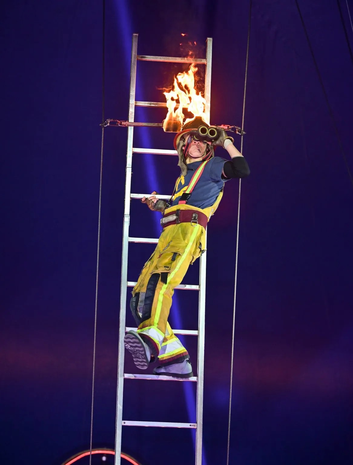 Firman act at Russell's International Circus in York, September 2026 ona ladder with helmet on fire