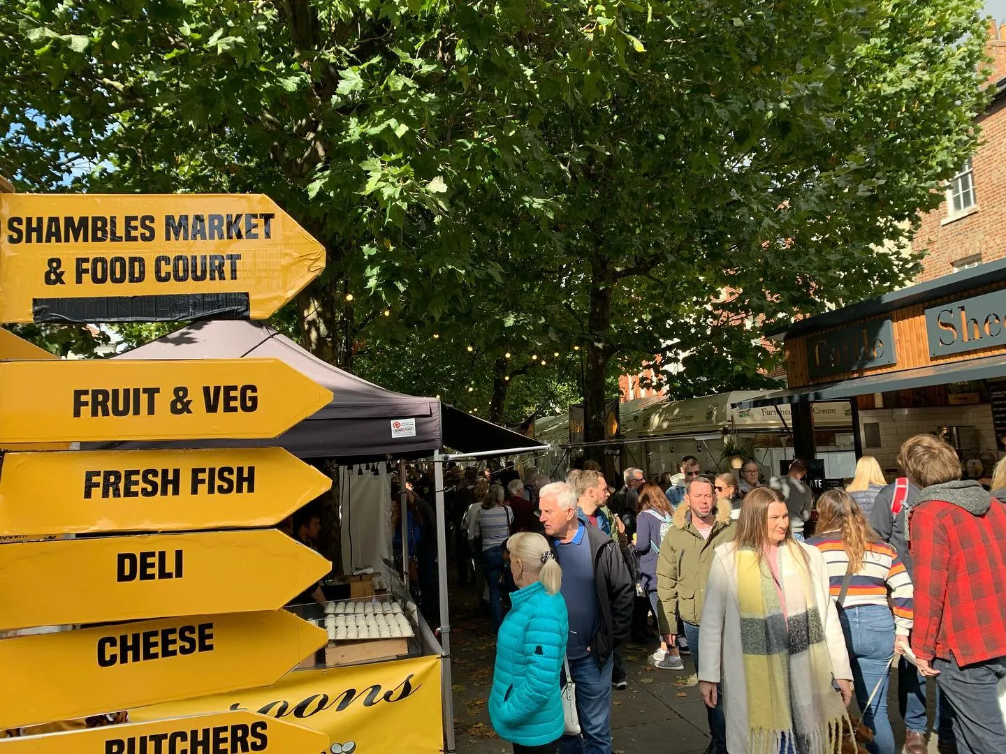 Bustling outdoor food market stalls and street food vendors at the York Food & Drink Festival in Parliament Street