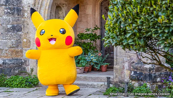 Pikachu outside a historic building at a national trust property, part of the Pokemon evolution trails taking place at National Trust sites including Fountain Abbey in Yorkshire for summer holidays 