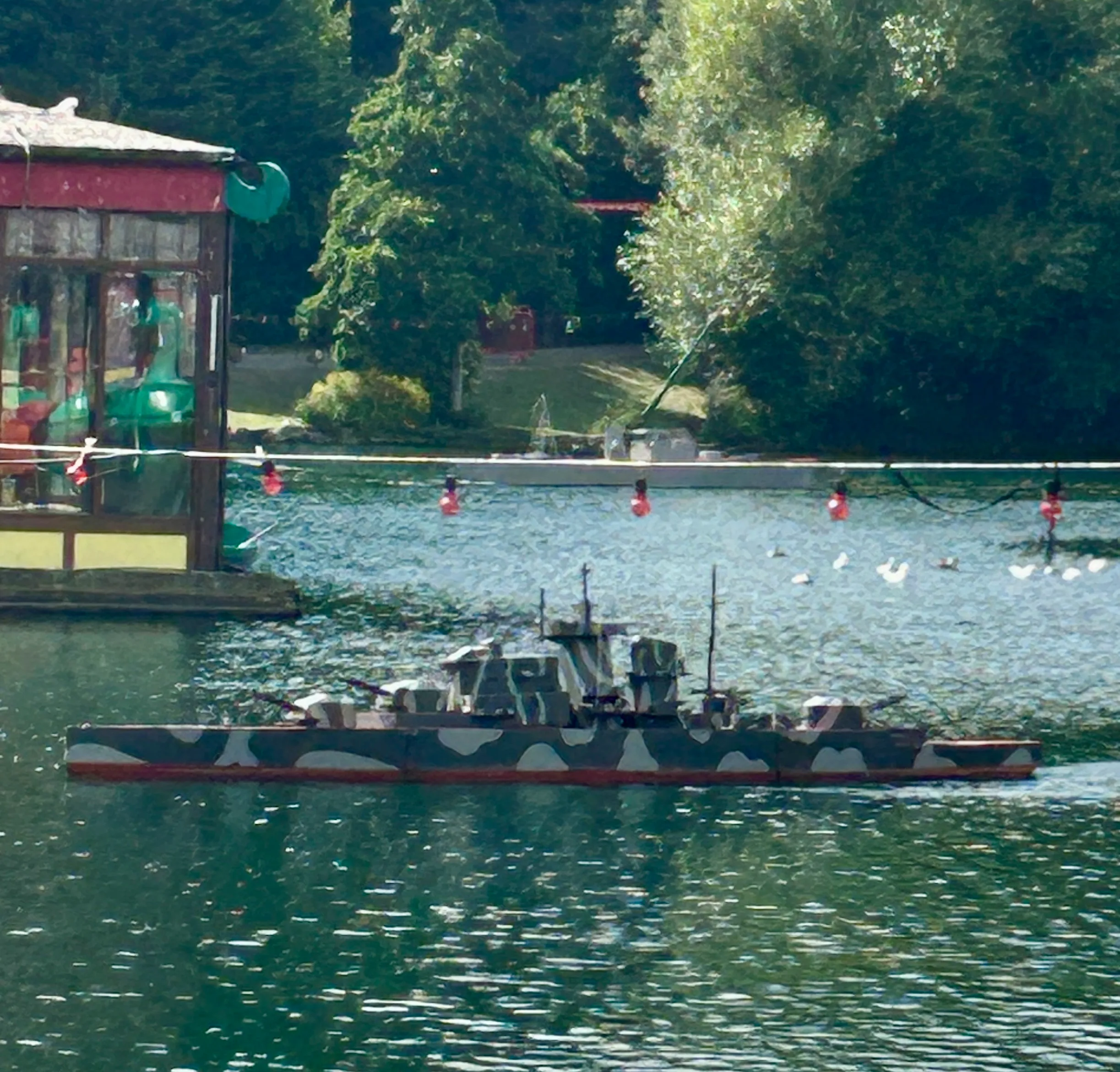 Naval warfare boat on the lake at peasholm park with the bandstand in the background Summer event