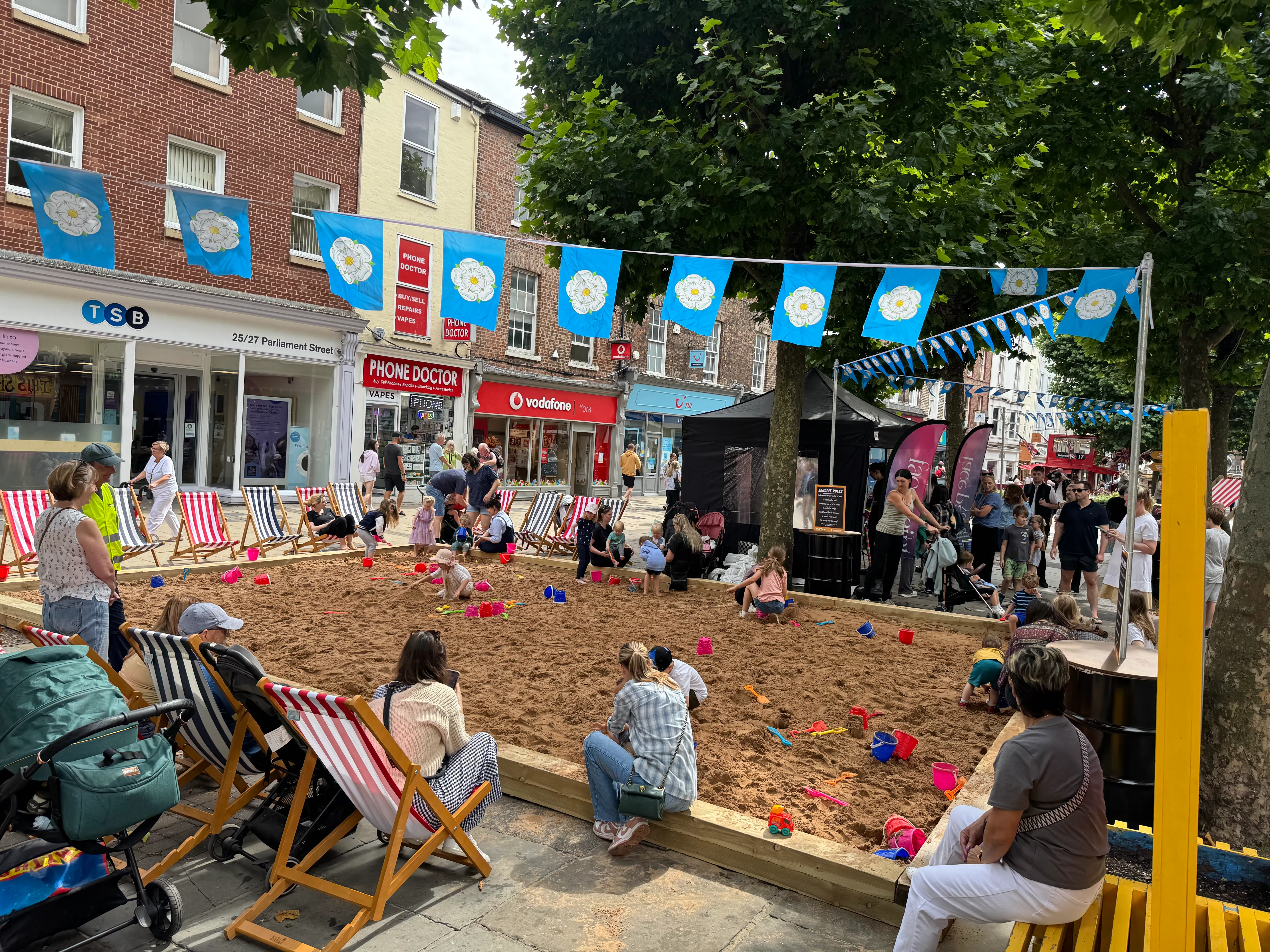 children playing in the seasdie zone, summer fun area in York. 