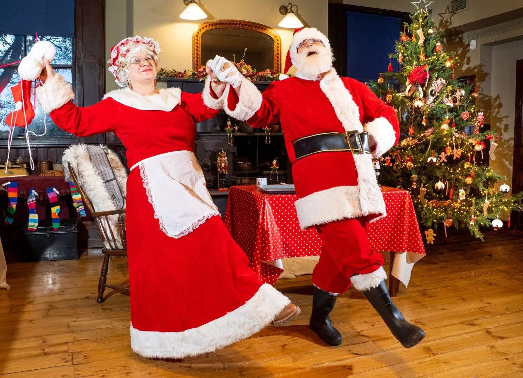 Mr and Mrs Claus holding hands