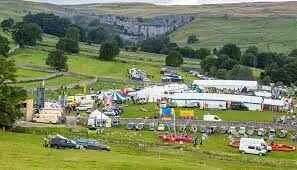 aerial shot of Malham showgound full of marquees, stalls and the events ring