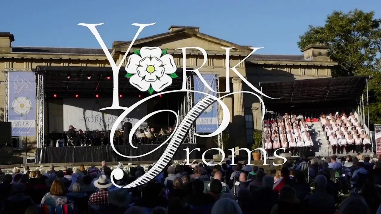 Audience in front of the stage at York Proms with The Yorkshire Museum in the background