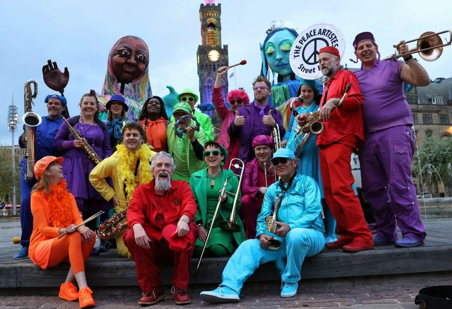 Musicians in brightly coloured clothing getered for the puppet pageant free event in Bradford, Yorkshire in March 2026.