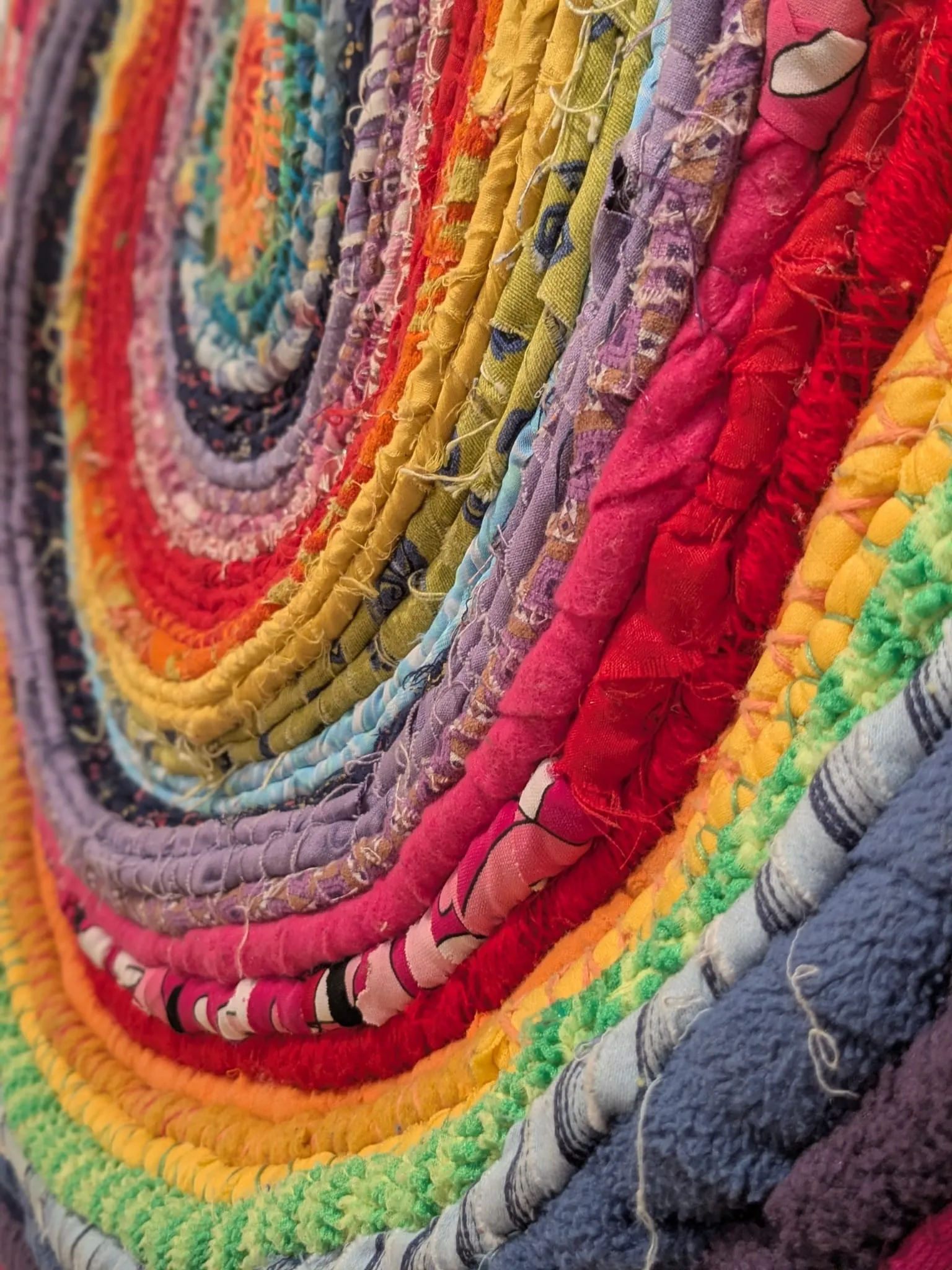 close up of concentric circles in brightly coloured yarn.