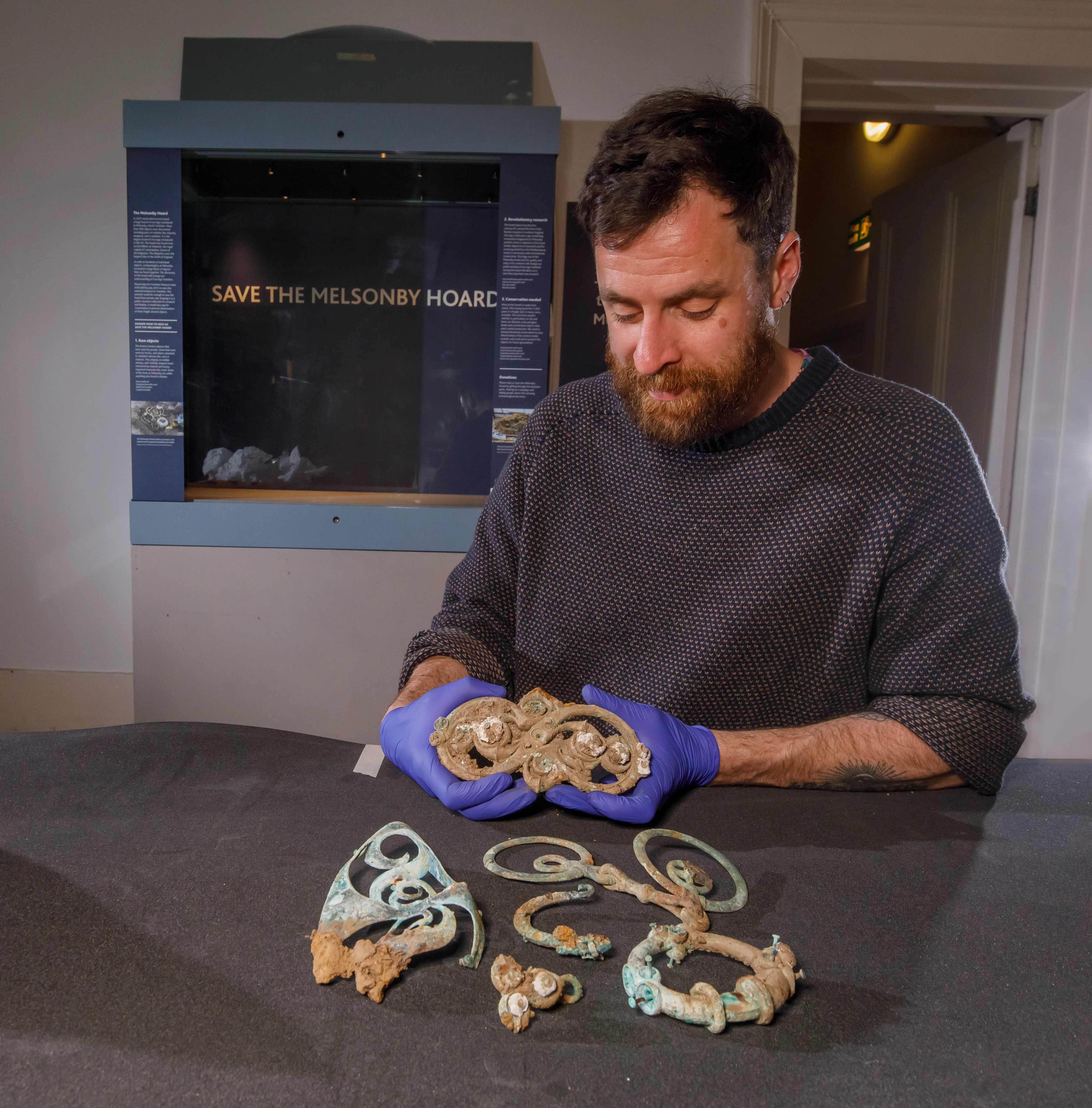 Dr Adam Parker with items from the melsonby hoard, on display at the Yokshire Museum in May 2026 photogrpah by Gareth Buddo