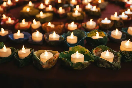 concentric circles of tea light candles all lit.