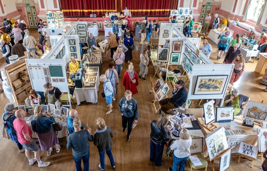 aerial view over the makers fair in Victoria hall, with stalls and customers browsing.
